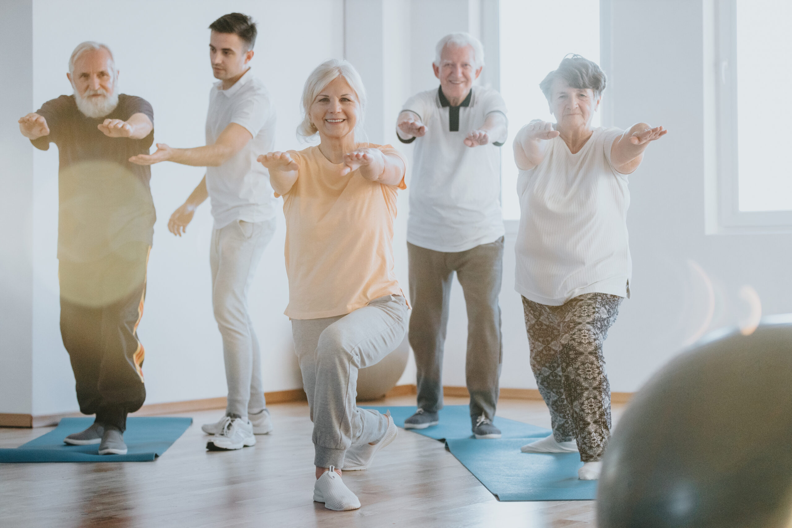 Group of senior people exercising together on a gym